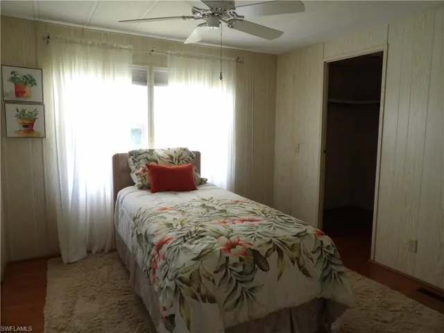Bedroom features wood flooring with spacious closets.