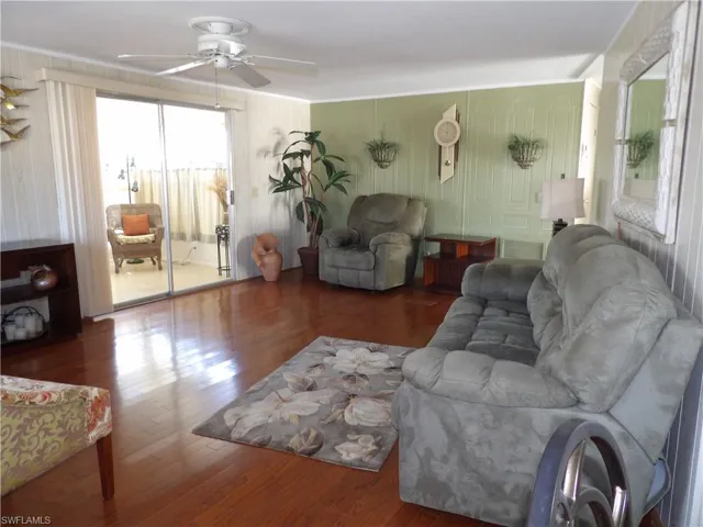 Living area featuring wood finished floors and a ceiling fan
