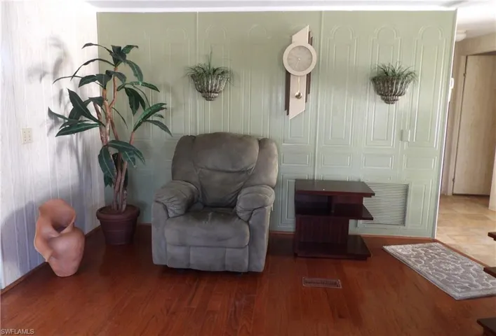 Sitting room featuring wood finished floors and baseboards