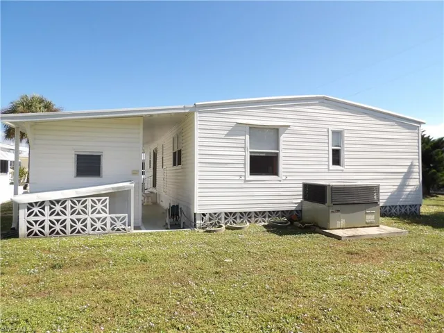 Rear view of property featuring a yard