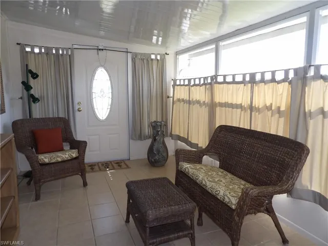Entryway with light tile patterned flooring