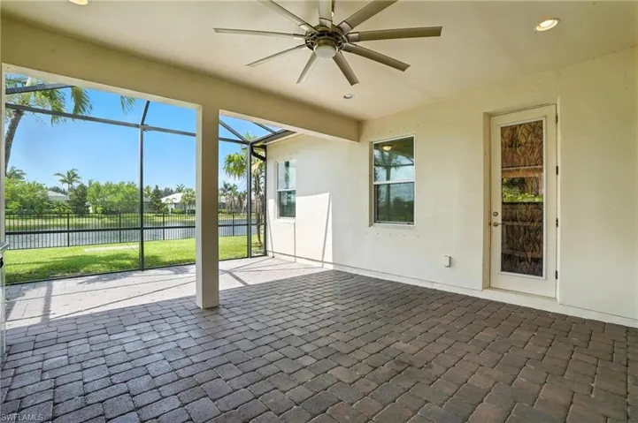 Unfurnished sunroom featuring a water view and ceiling fan