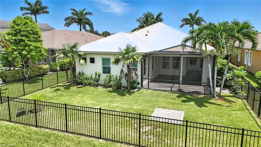 Rear view of property featuring a fenced backyard, stucco siding, and a patio