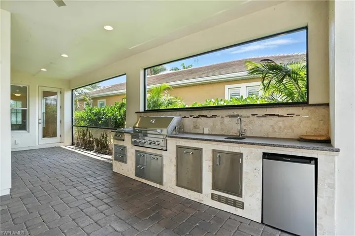View of patio / terrace featuring an outdoor kitchen and a sink