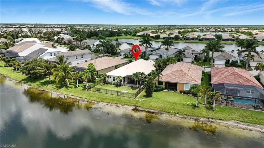Aerial view of residential area featuring a large body of water