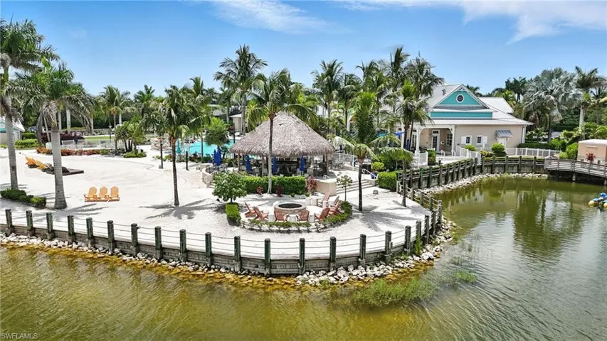 View of property's community with a fire pit, a gazebo, a water view, and a patio area