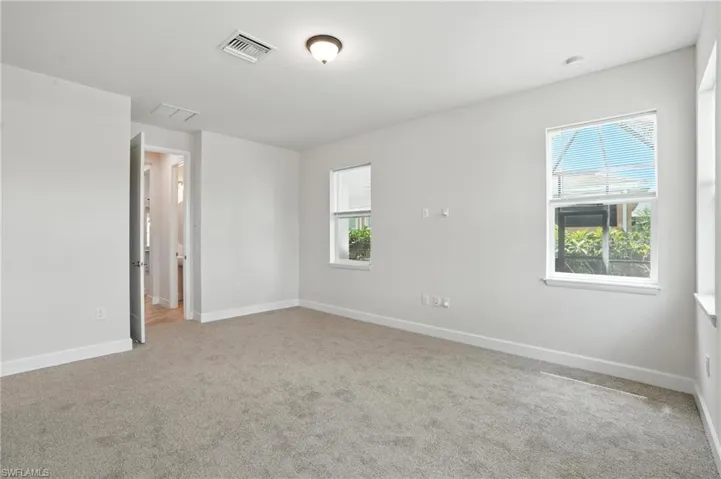Unfurnished room with carpet floors and baseboards