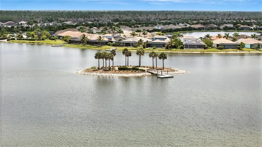 Aerial perspective of suburban area with a nearby body of water