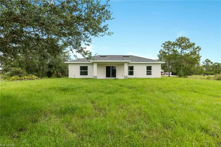 Back of house featuring a lawn