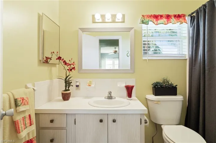 Bathroom featuring toilet, tasteful backsplash, and vanity