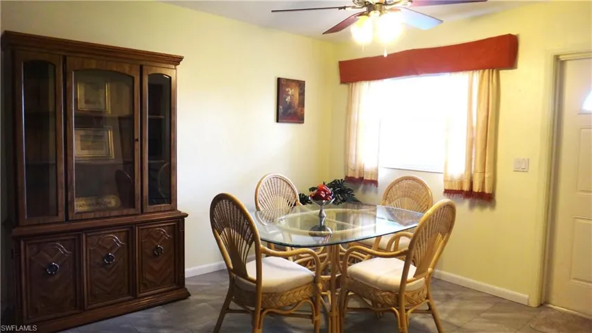 Tiled dining space featuring ceiling fan
