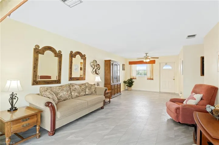 Living room featuring neutral tile floors