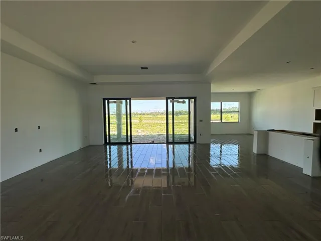Spare room with dark hardwood / wood-style flooring