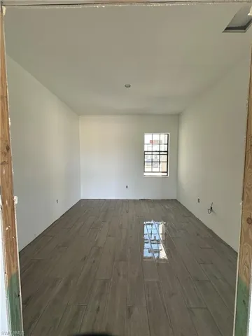 Spare room featuring dark hardwood / wood-style floors