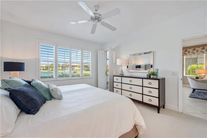 Bedroom with ceiling fan and light colored carpet