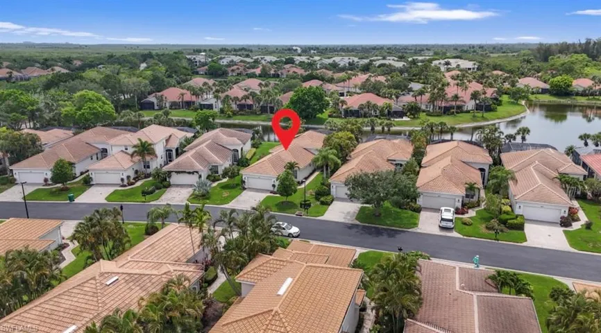 Aerial perspective of suburban area with a nearby body of water