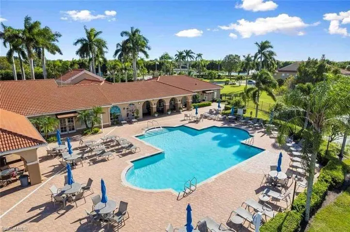 Community pool with a patio