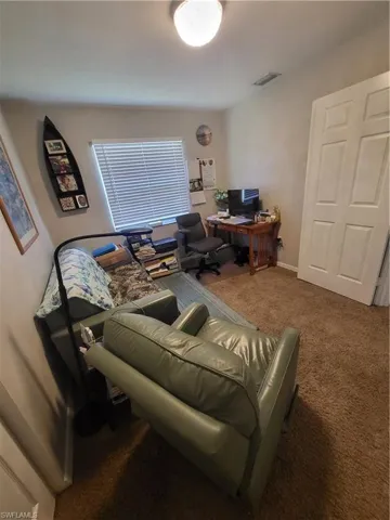Home office with carpet floors and baseboards