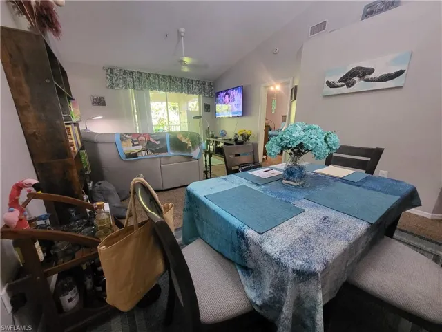 Dining area featuring lofted ceiling and baseboards