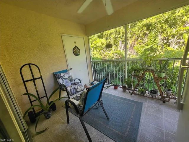 Patio / terrace featuring a sunroom and a ceiling fan