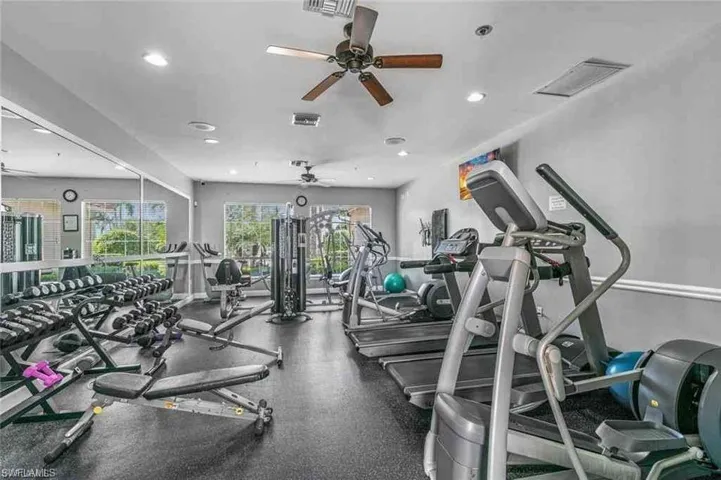 Workout area featuring ceiling fan and recessed lighting