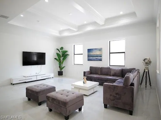 Living area with beam ceiling, healthy amount of natural light, and recessed lighting