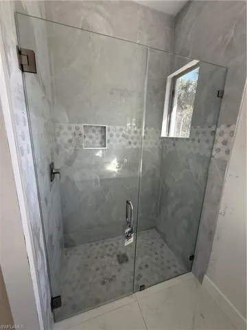 Bathroom with a marble finish shower