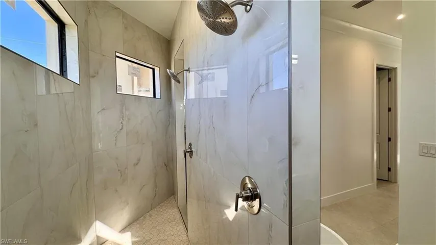 Bathroom featuring a marble finish shower