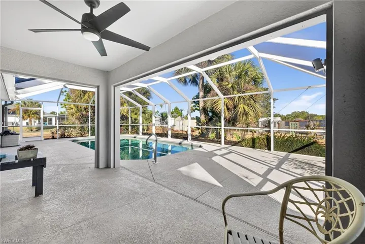 Outdoor pool with a sunroom, a patio, and a lanai