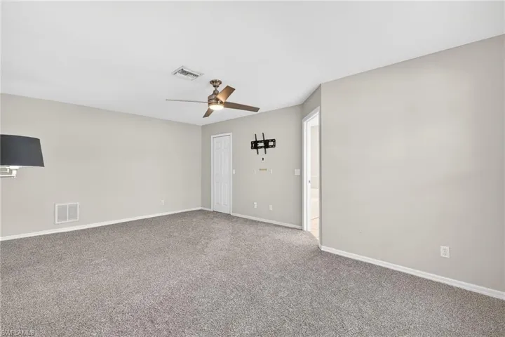 Spare room featuring carpet floors and ceiling fan