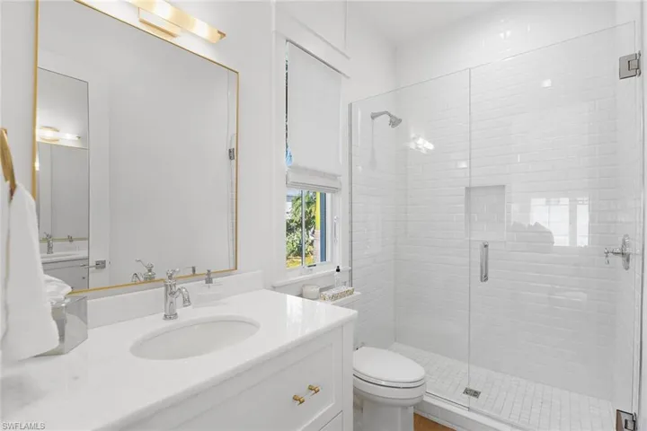 Full bath featuring vanity and a shower stall