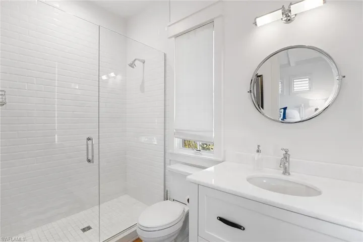 Full bathroom featuring vanity and a stall shower