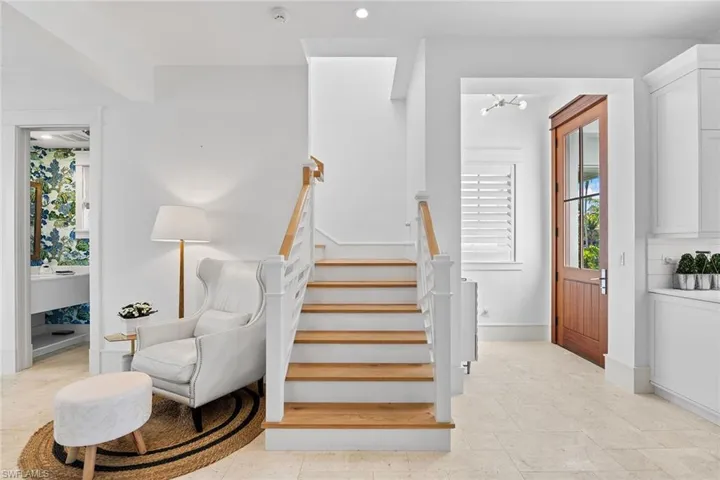 Staircase featuring recessed lighting and baseboards