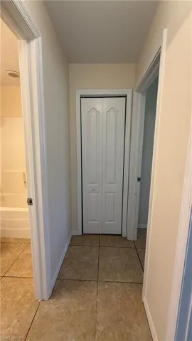 Hallway featuring tile flooring and a bi-fold door