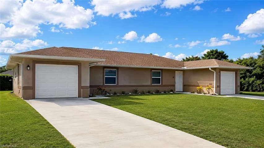 Contemporary stucco exterior with a brown shingle roof, twin garage doors, a concrete driveway, and established green landscaping