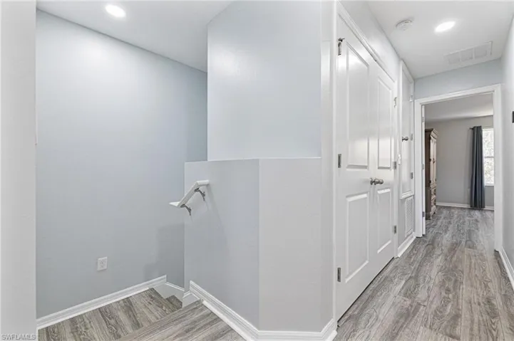 Hall with light hardwood / wood-style flooring