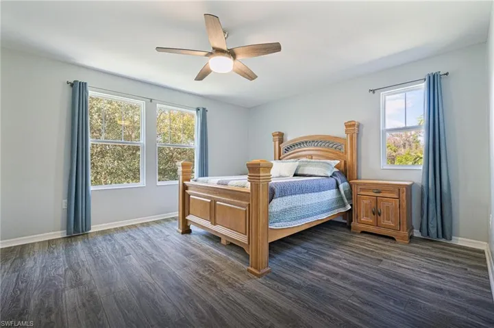 Bedroom featuring ceiling fan and dark hardwood / wood-style floors