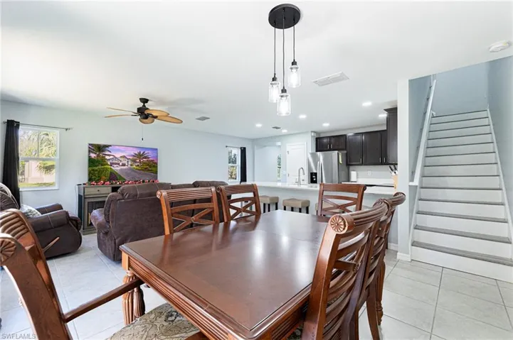 Tiled dining room featuring sink and ceiling fan