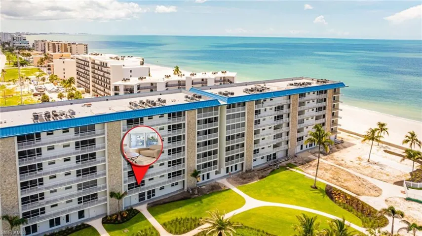 Drone / aerial view of apartment complex and expansive coastline