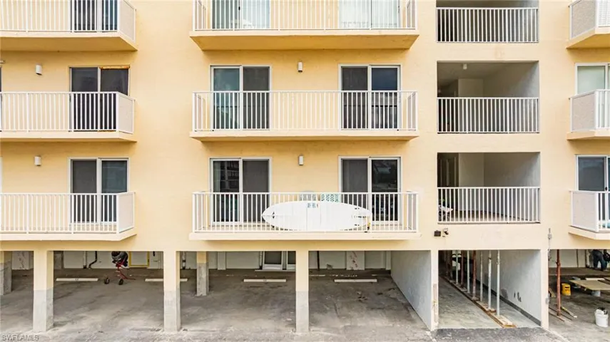 View of apartment building / complex with covered parking
