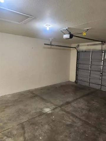 Garage featuring a garage door opener