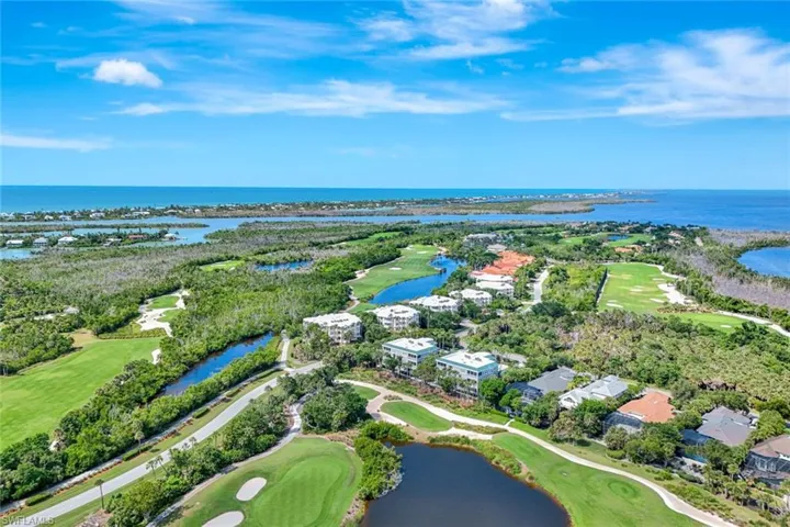 Drone / aerial view of a golf course and a large body of water