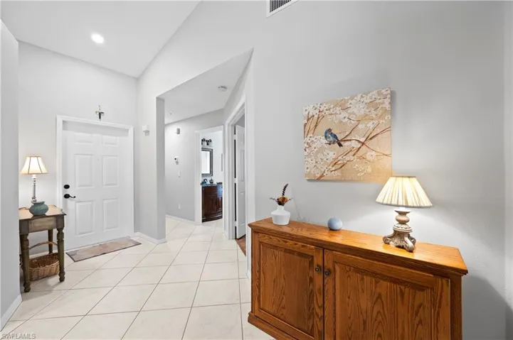 Entryway featuring light tile patterned flooring and baseboards