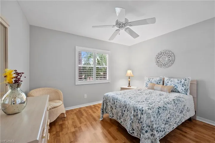 Bedroom with wood finished floors and a ceiling fan