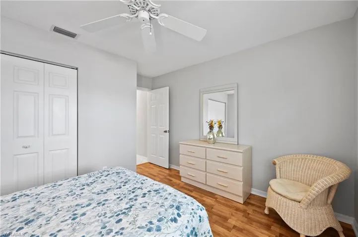 Bedroom featuring a closet, light wood-type flooring, and a ceiling fan