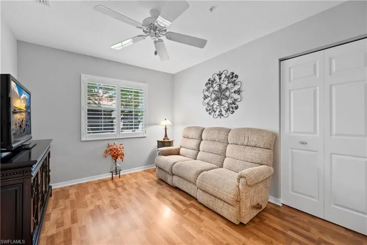 Living room with a ceiling fan and light wood-style floors