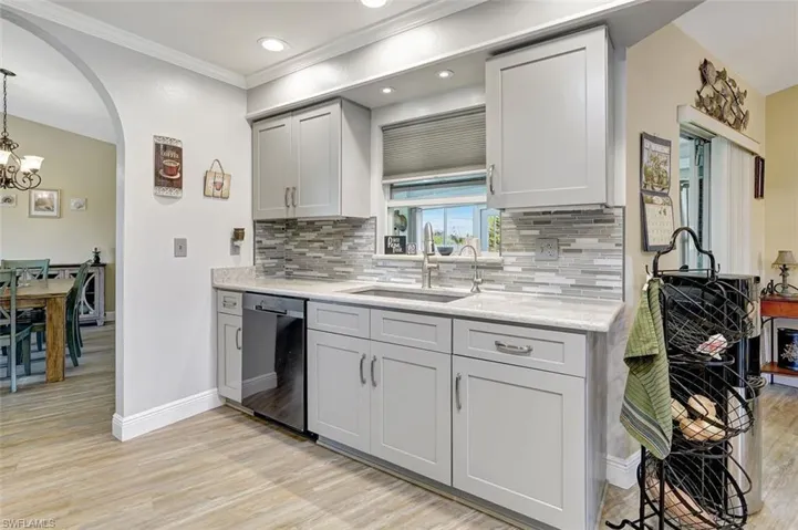 Kitchen featuring stainless steel appliances, undercounter lighting, quartz counters and backsplash