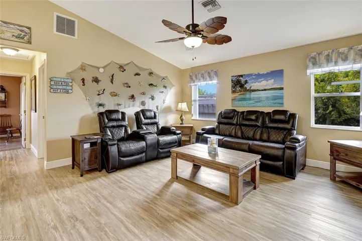 Family room with ceiling fan and light hardwood / wood-style flooring