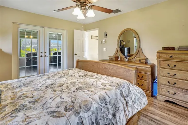 Bedroom featuring ceiling fan, french doors, access to exterior, and light hardwood / wood-style flooring