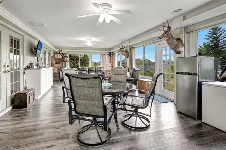Sun room featuring ceiling fan and french doors